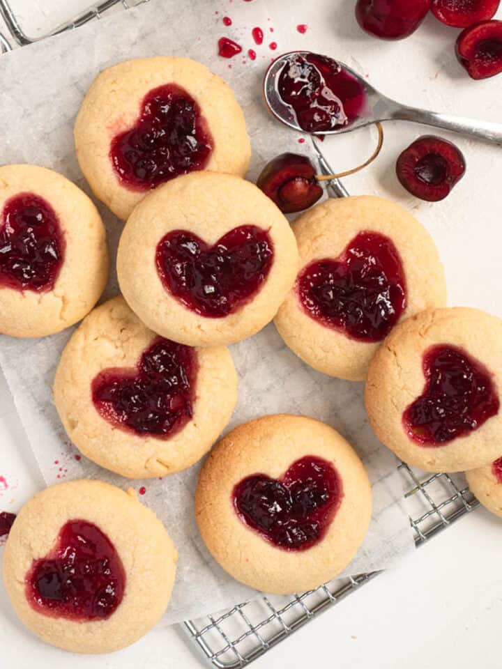 Heart shaped thumbprint cookies filled with fresh homemade cherry jam