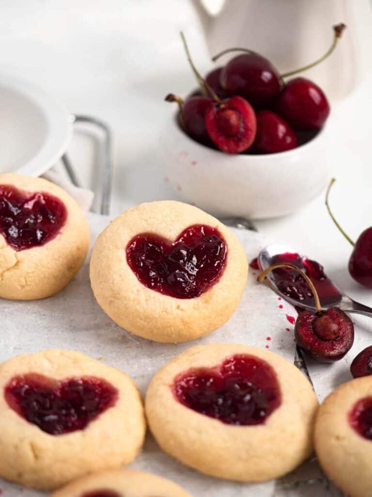 Heart shaped thumbprint cookies filled with fresh homemade cherry jam