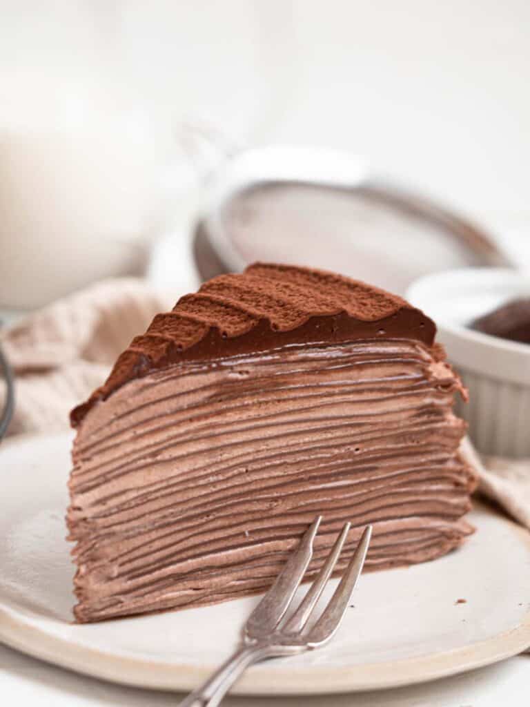 Chocolate mille crepe cake with chocolate whipped cream and ganache