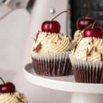 Chocolate cupcakes with vanilla whipped cream and rum soaked cherries