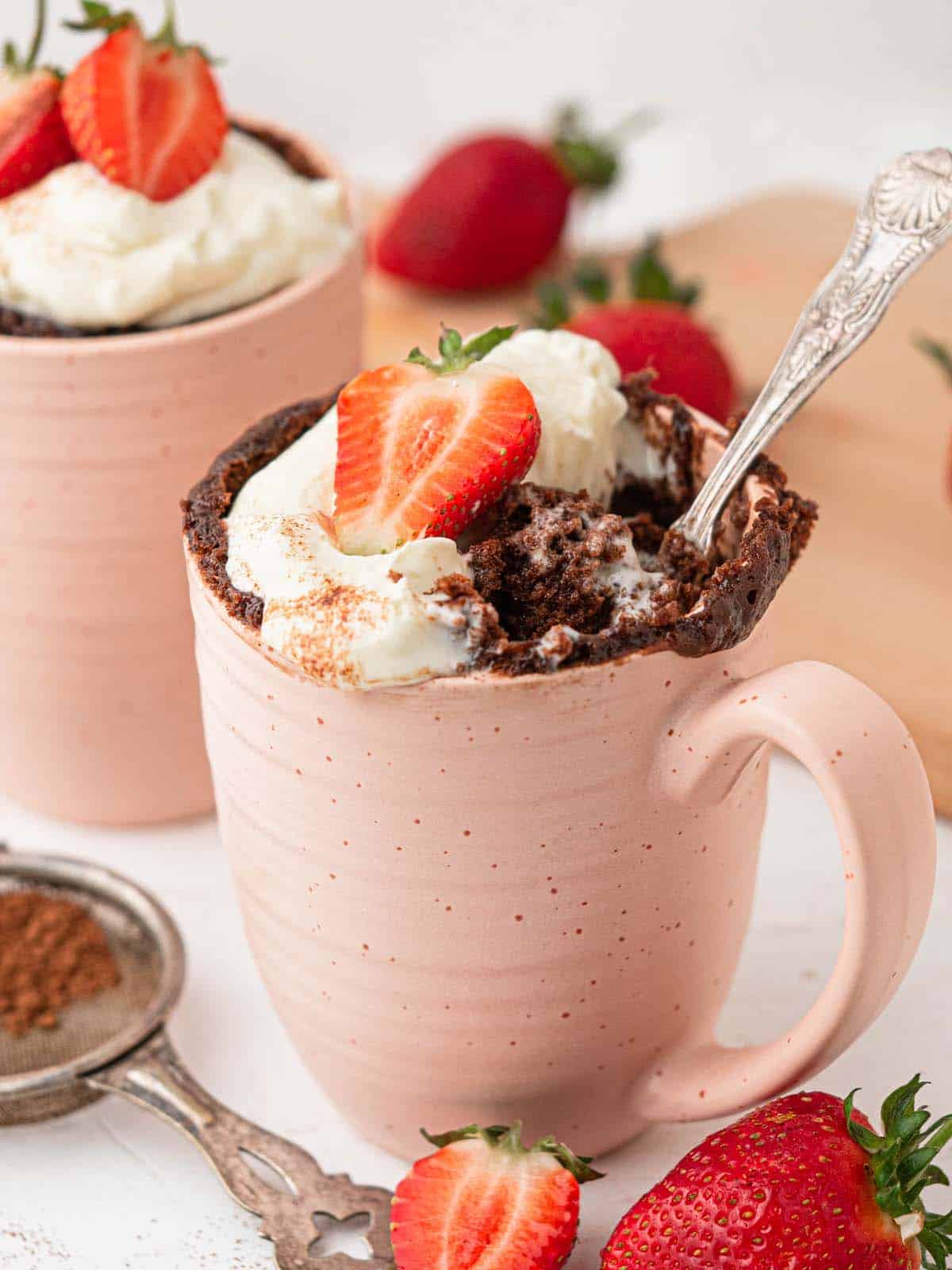 4 ingredient 4 minute chocolate hazelnut Nutella mug cake with whipped cream and strawberries