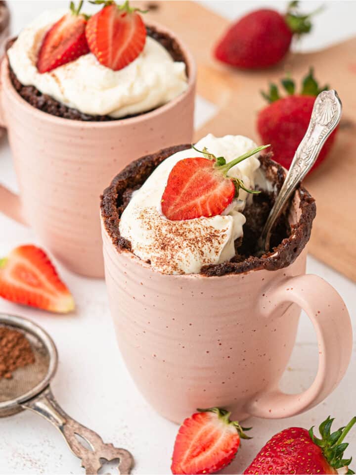 4 ingredient 4 minute chocolate hazelnut Nutella mug cake with whipped cream and strawberries