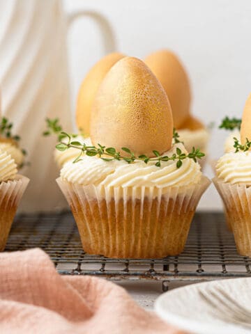 Lemon curd filled easter white chocolate cupcakes with a golden egg