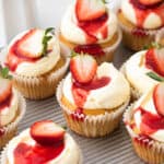 Strawberry shortcake cupcakes with strawberry sauce and whipped cream