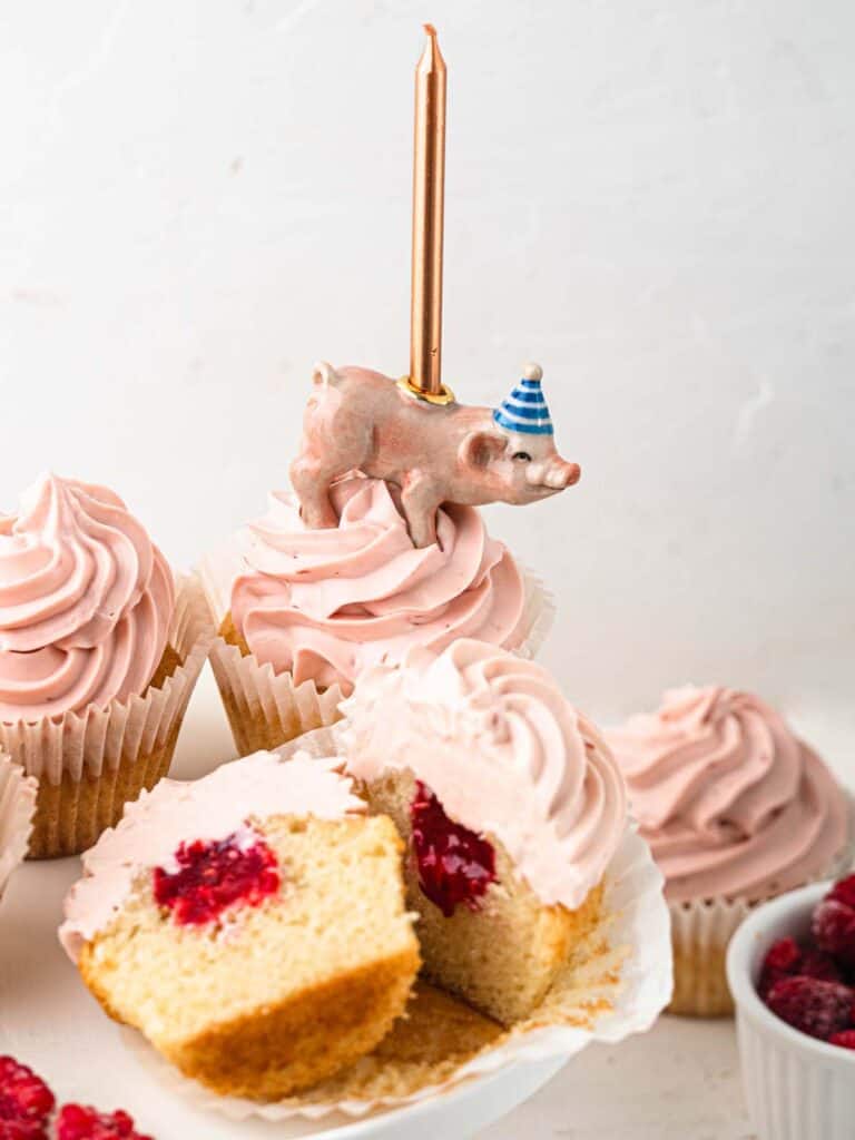 Vanilla cupcakes filled with raspberry jam topped with raspberry cream cheese frosting