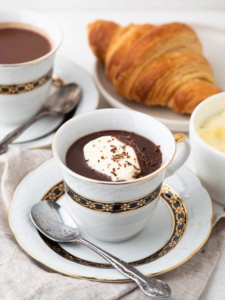 French hot chocolate with whipped cream and croissant