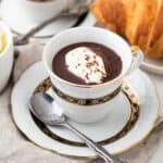 French hot chocolate with whipped cream and croissant