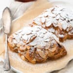 Small batch almond croissants dusted in icing sugar