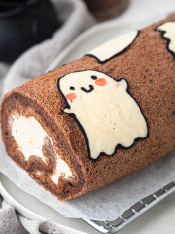 Halloween ghost chocolate swiss roll cake with vanilla whipped cream