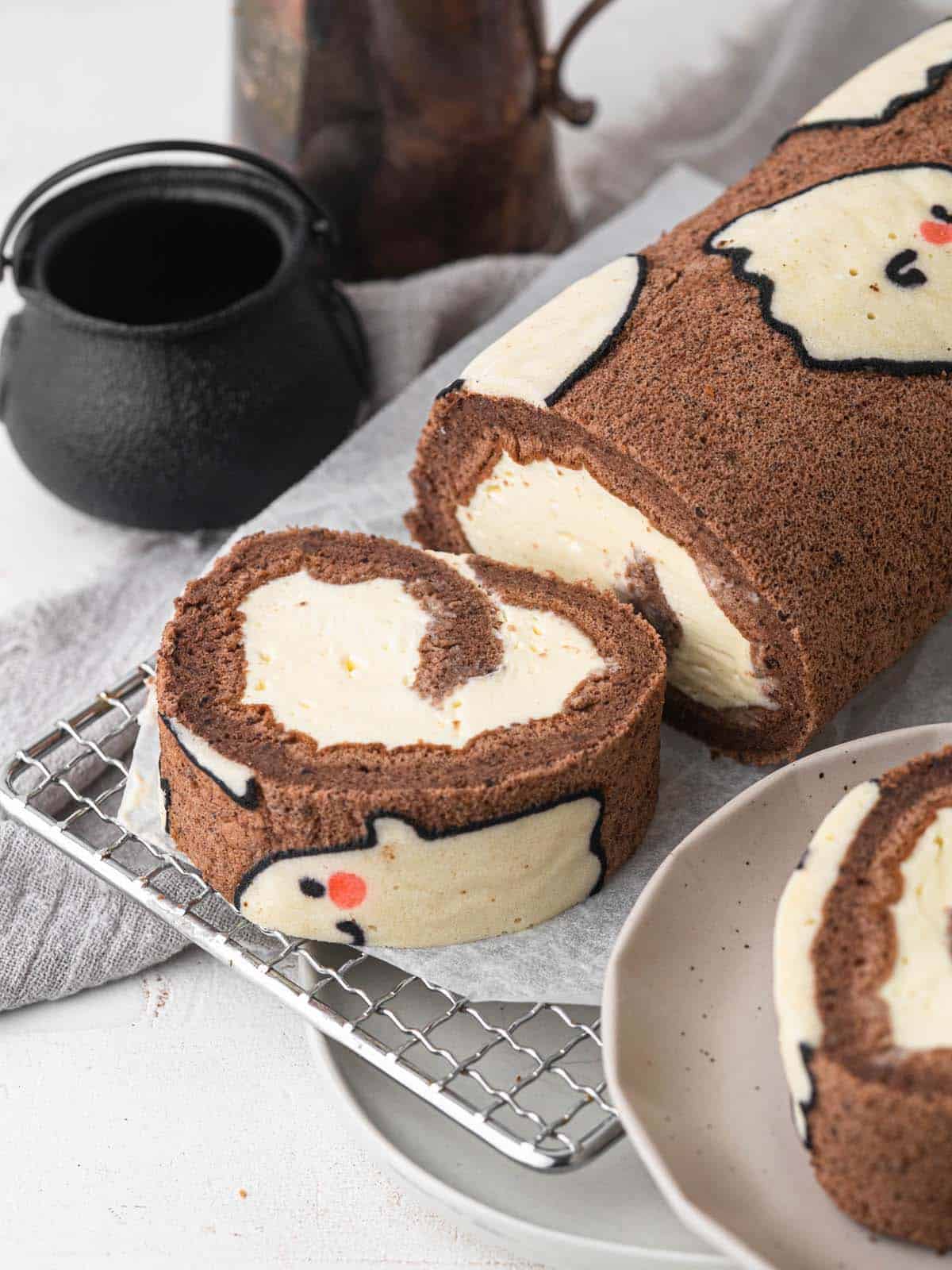 Halloween ghost chocolate swiss roll cake with vanilla whipped cream