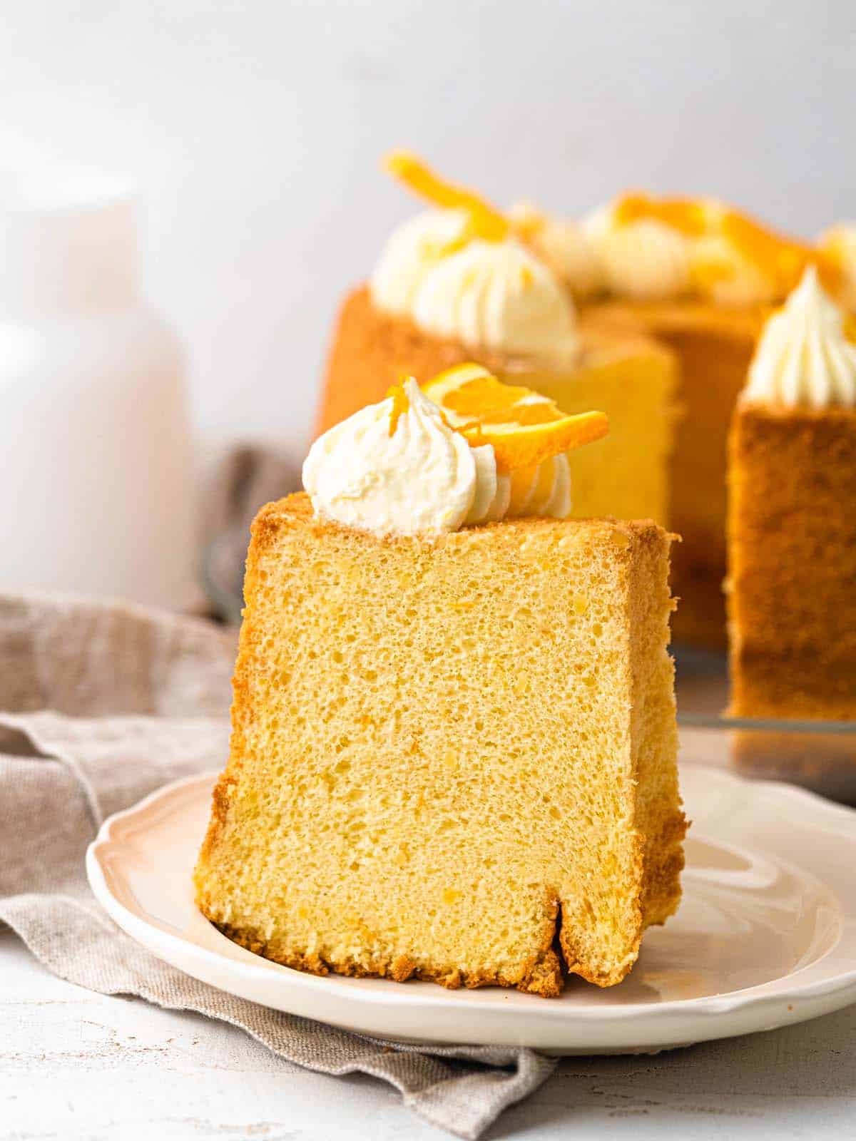 Orange chiffon cake topped with whipped cream