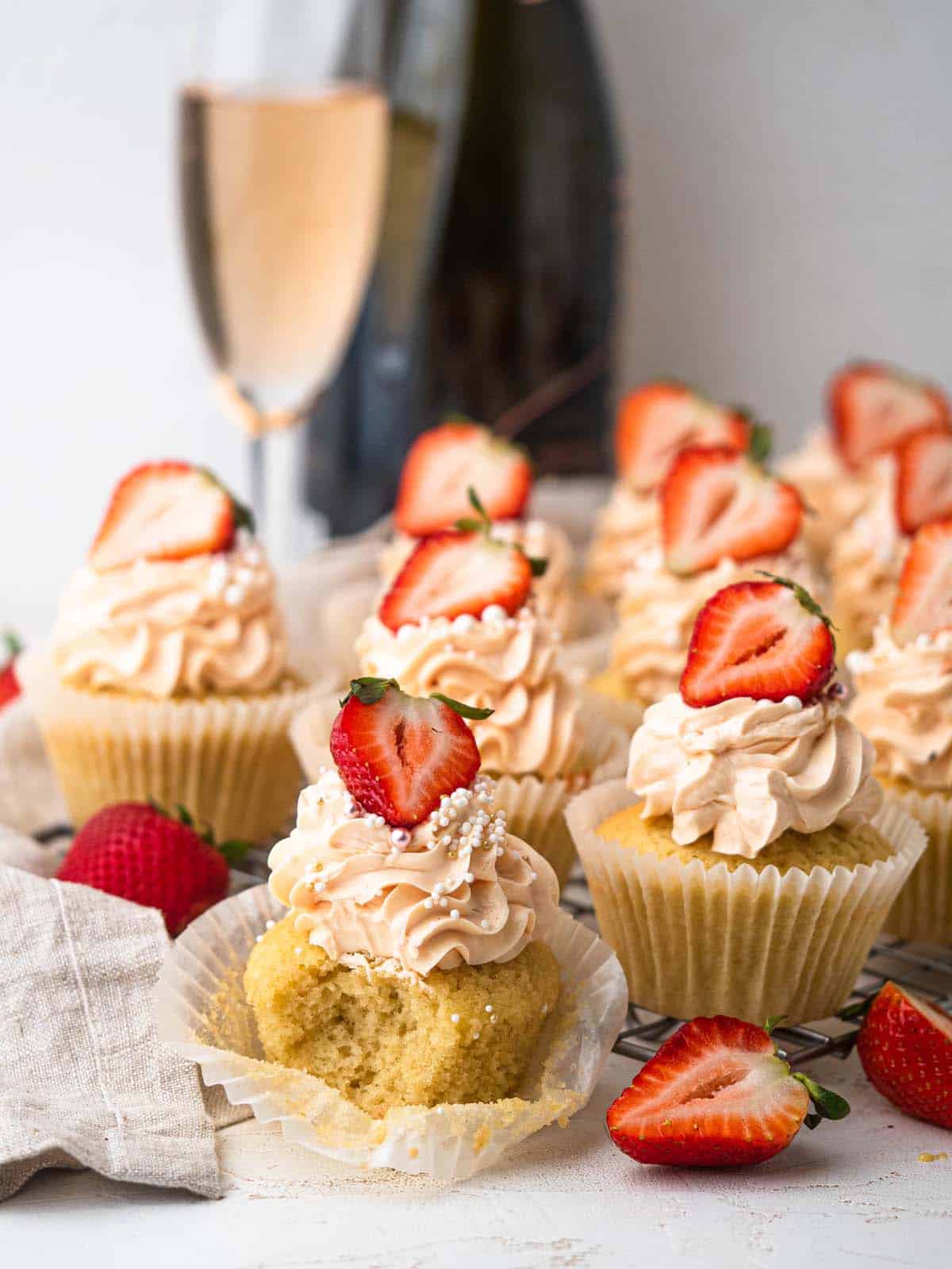 pink champagne cupcakes topped with buttercream and strawberries