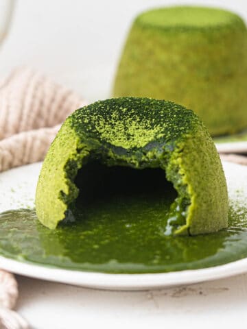 Matcha lava cake topped with vanilla ice cream and green tea powder