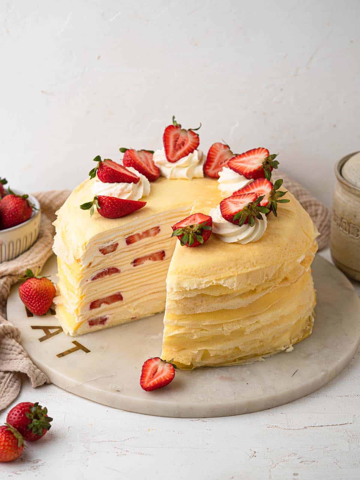 strawberry mille crepe cake filled with vanilla whipped cream and fresh strawberries
