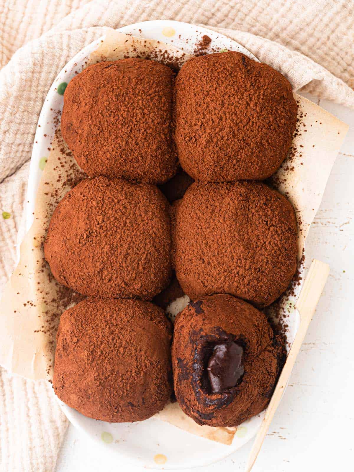 chocolate mochi filled with gooey chocolate ganache dusted with cocoa powder