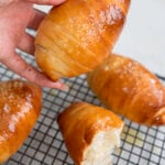 Soft homemade milk bread rolls cooling on wire rack