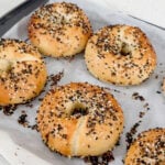 Everything bagels with sesame and poppy seeds on tray