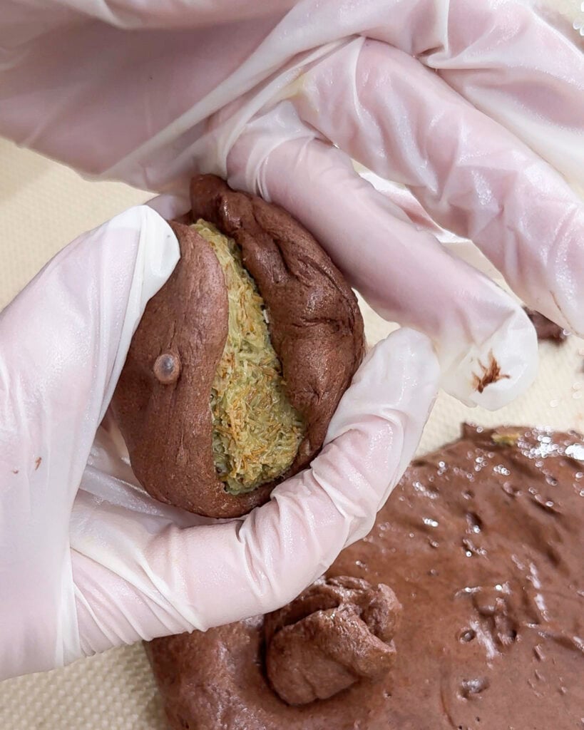Hand holding portion of chocolate marshmallow dough - Catherine Zhang Hand holding portion of chocolate marshmallow dough