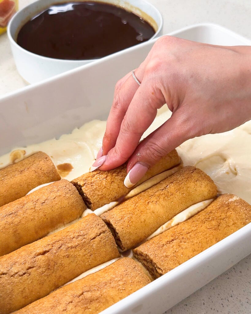 Placing ladyfinger biscuits into tiramisu layer - Catherine Zhang Placing ladyfinger biscuits into tiramisu layer