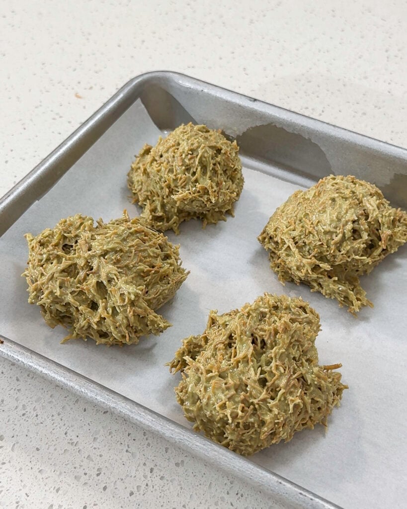 Scooped pistachio kataifi mixture portions placed on parchment - Catherine Zhang Scooped pistachio kataifi mixture portions placed on parchment