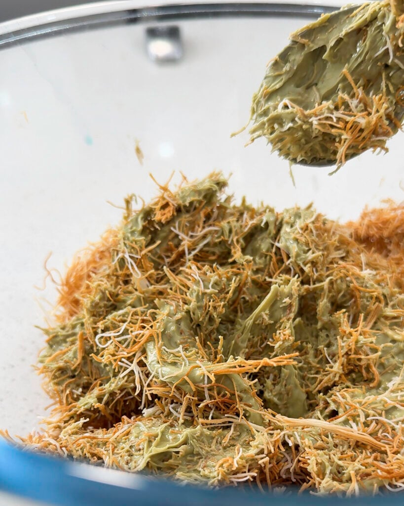 A scoop of green paste is visible in a bowl - Catherine Zhang A scoop of green paste is visible in a bowl