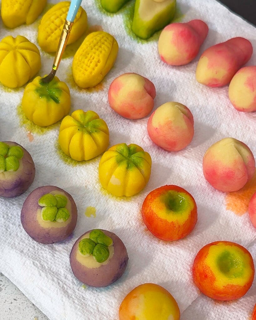 Dipping Luk Chup fruit shape into glaze for coating - Catherine Zhang Dipping Luk Chup fruit shape into glaze for coating