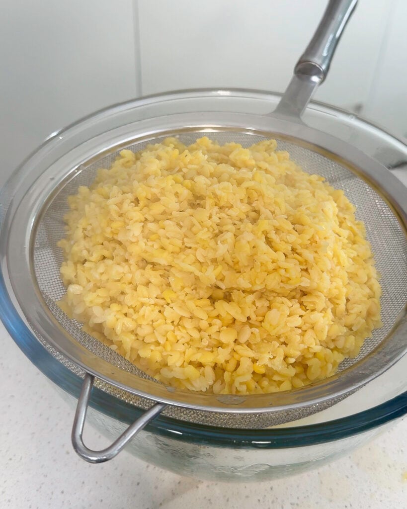 Drained softened mung beans in sieve - Catherine Zhang Drained softened mung beans in sieve