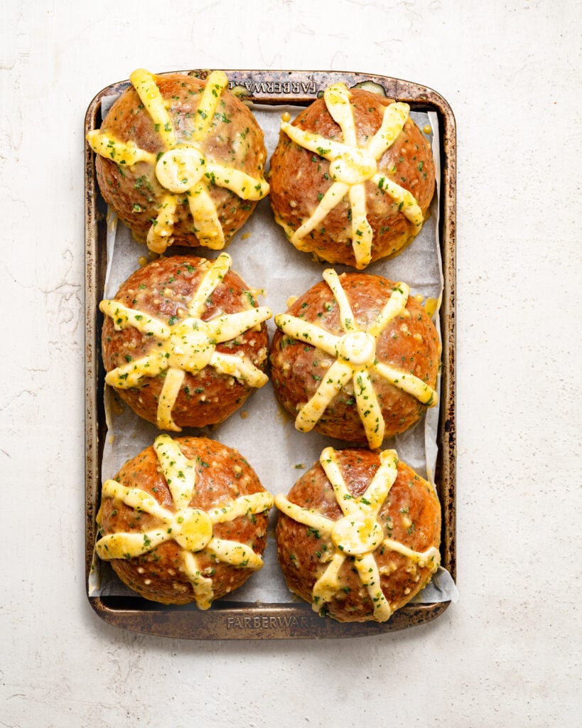 Filled buns coated with yellow herb mixture on a tray - Catherine Zhang Filled buns coated with yellow herb mixture on a tray