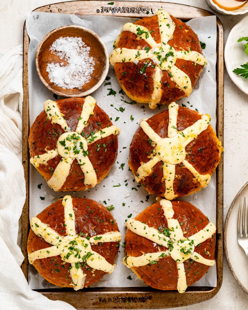 Glossy golden buns with cream filling and herbs on a tray for Korean cream cheese garlic bread - Catherine Zhang Glossy golden buns with cream filling and herbs on a tray for Korean cream cheese garlic bread