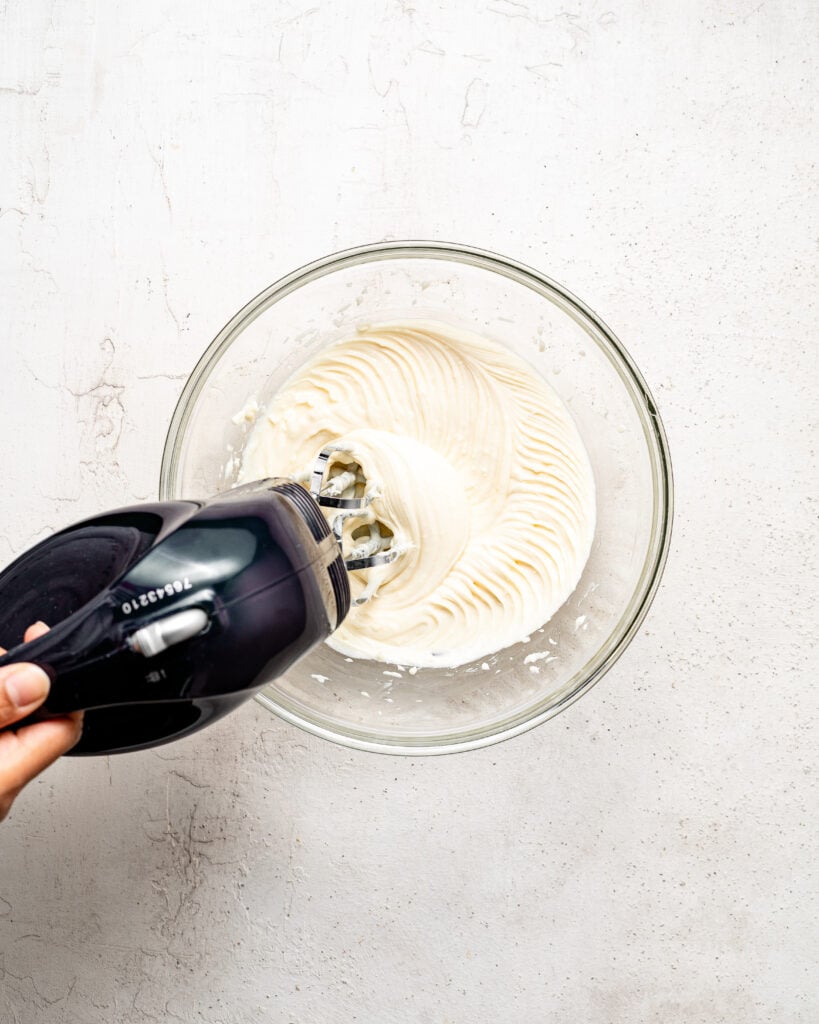 White creamy filling being mixed in a glass bowl - Catherine Zhang White creamy filling being mixed in a glass bowl