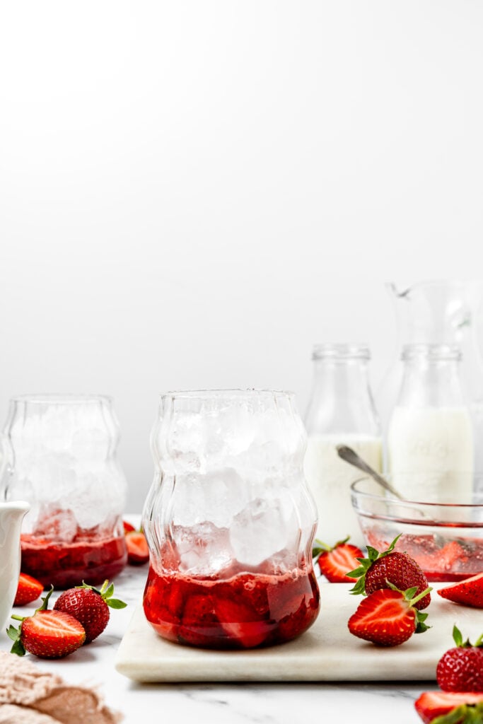 strawberry mixture and ice cubes in a clear wavy glass - Catherine Zhang strawberry mixture and ice cubes in a clear wavy glass