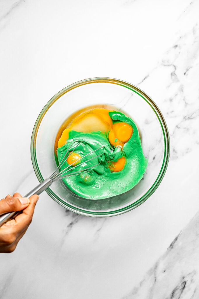 Egg yolks whisked with green pandan mixture for pandan chiffon cake batter - Catherine Zhang Egg yolks whisked with green pandan mixture for pandan chiffon cake batter