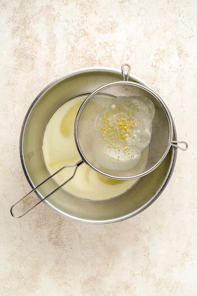 Fine mesh sieve with strained residue over a bowl for Pandan Kaya Jam - Catherine Zhang Fine mesh sieve with strained residue over a bowl for Pandan Kaya Jam