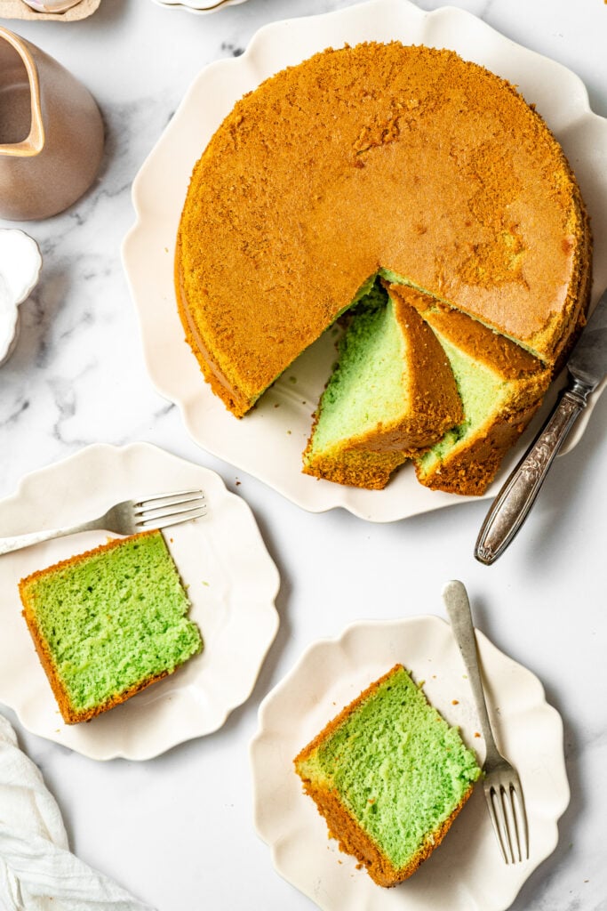 Finished pandan chiffon cake with green slices served on plates - Catherine Zhang Finished pandan chiffon cake with green slices served on plates