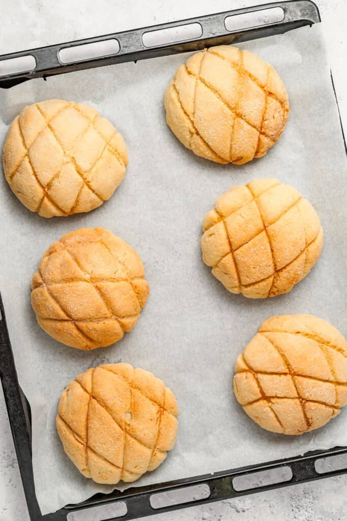 Melon Pan buns arranged on a baking tray with crisscross topping