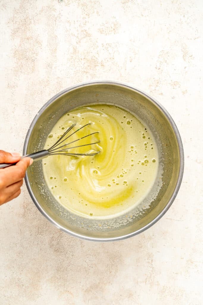Pale green Pandan Kaya Jam mixture being mixed in a metal bowl - Catherine Zhang Pale green Pandan Kaya Jam mixture being mixed in a metal bowl
