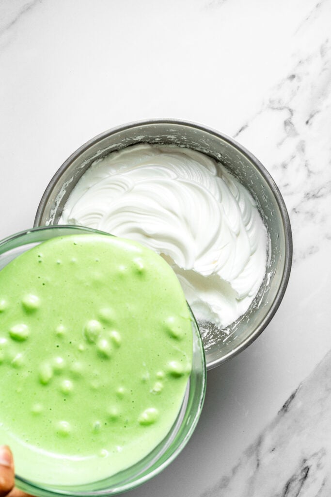 Pale green pandan mixture poured into white meringue for pandan chiffon cake - Catherine Zhang Pale green pandan mixture poured into white meringue for pandan chiffon cake
