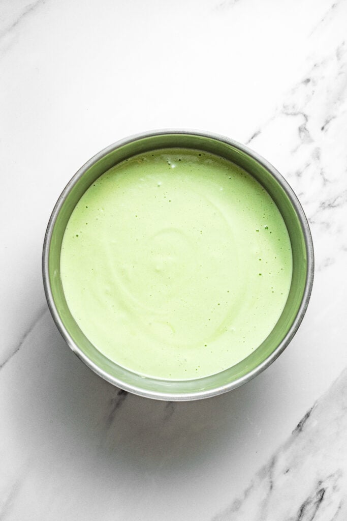 Pandan chiffon cake batter in a round metal cake pan before baking - Catherine Zhang Pandan chiffon cake batter in a round metal cake pan before baking
