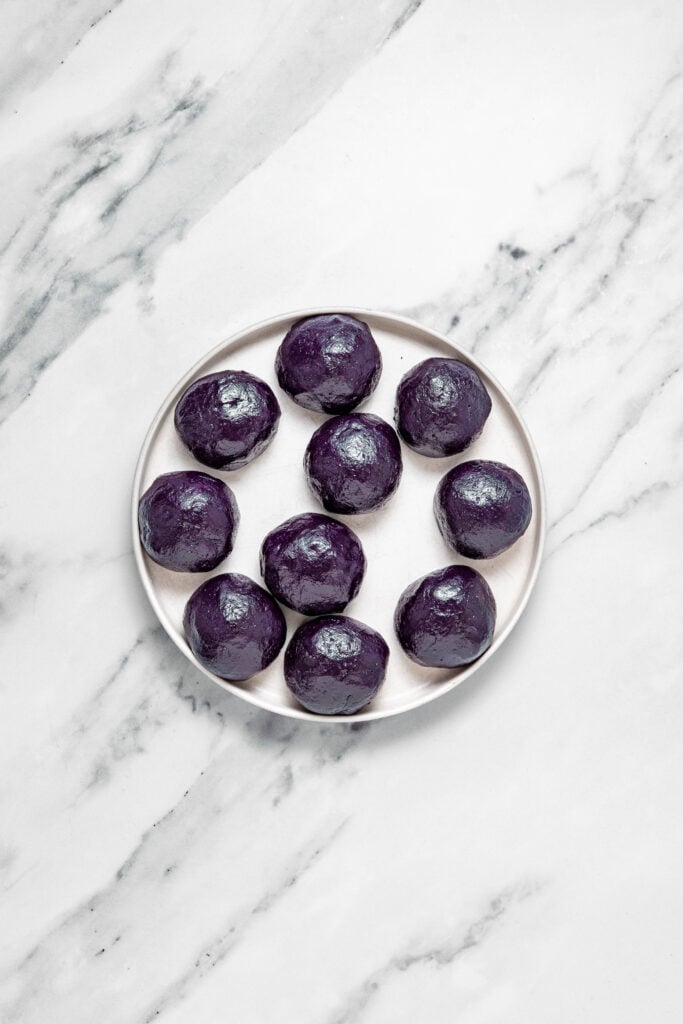 Rolled dark purple dough balls on a plate - Catherine Zhang Rolled dark purple dough balls on a plate