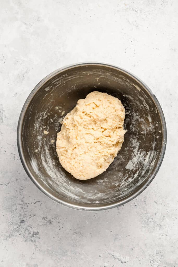 Rough Melon Pan bread dough formed in a metal mixing bowl