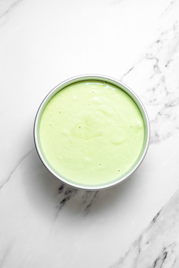 Smooth pandan chiffon cake batter filled in a round metal cake pan - Catherine Zhang Smooth pandan chiffon cake batter filled in a round metal cake pan