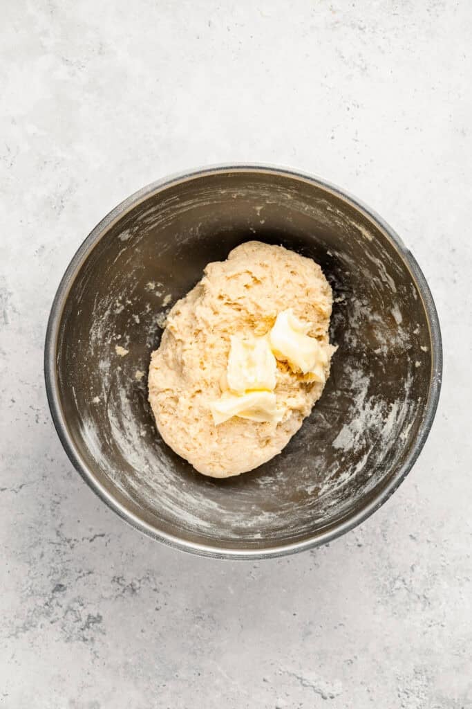 Softened butter added to rough Melon Pan dough in a mixing bowl