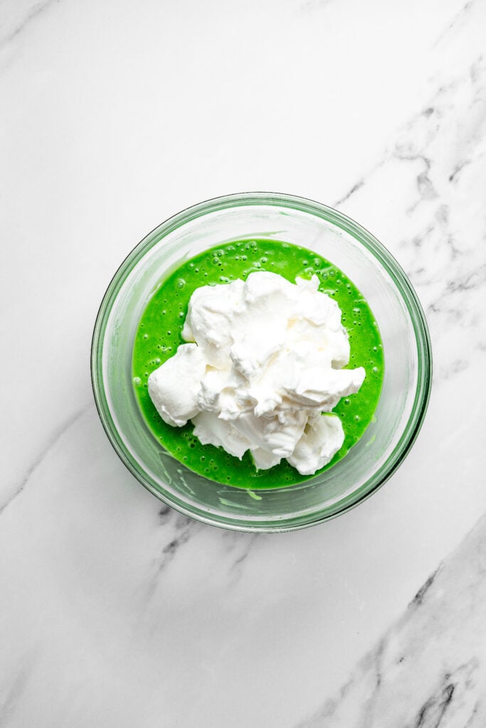 White meringue added to green pandan mixture for pandan chiffon cake batter - Catherine Zhang White meringue added to green pandan mixture for pandan chiffon cake batter