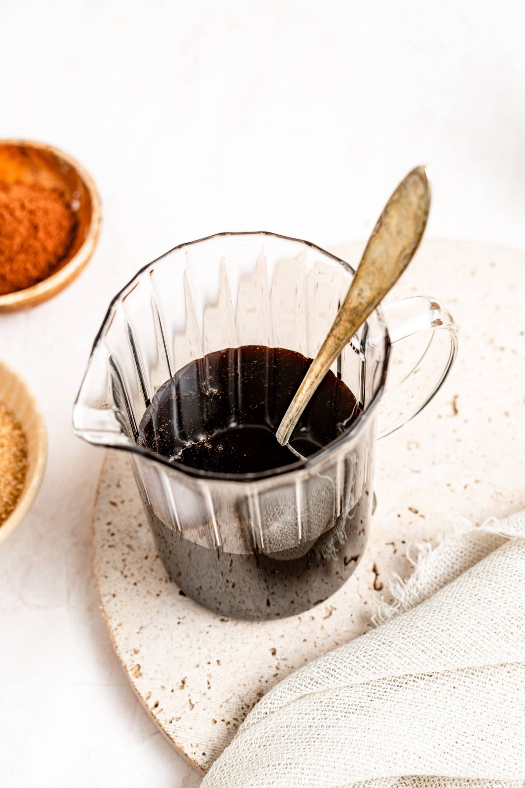 Finished kuromitsu black sugar syrup in a glass jar with a spoon - Catherine Zhang Finished kuromitsu black sugar syrup in a glass jar with a spoon