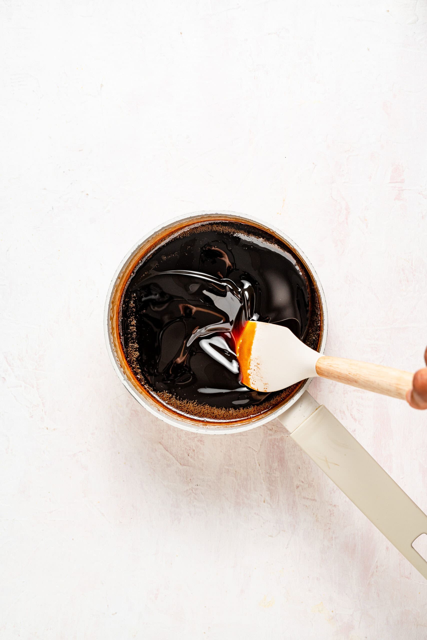 Spatula coat test showing kuromitsu syrup thick enough to coat a spoon - Catherine Zhang Spatula coat test showing kuromitsu thick enough to coat a spoon