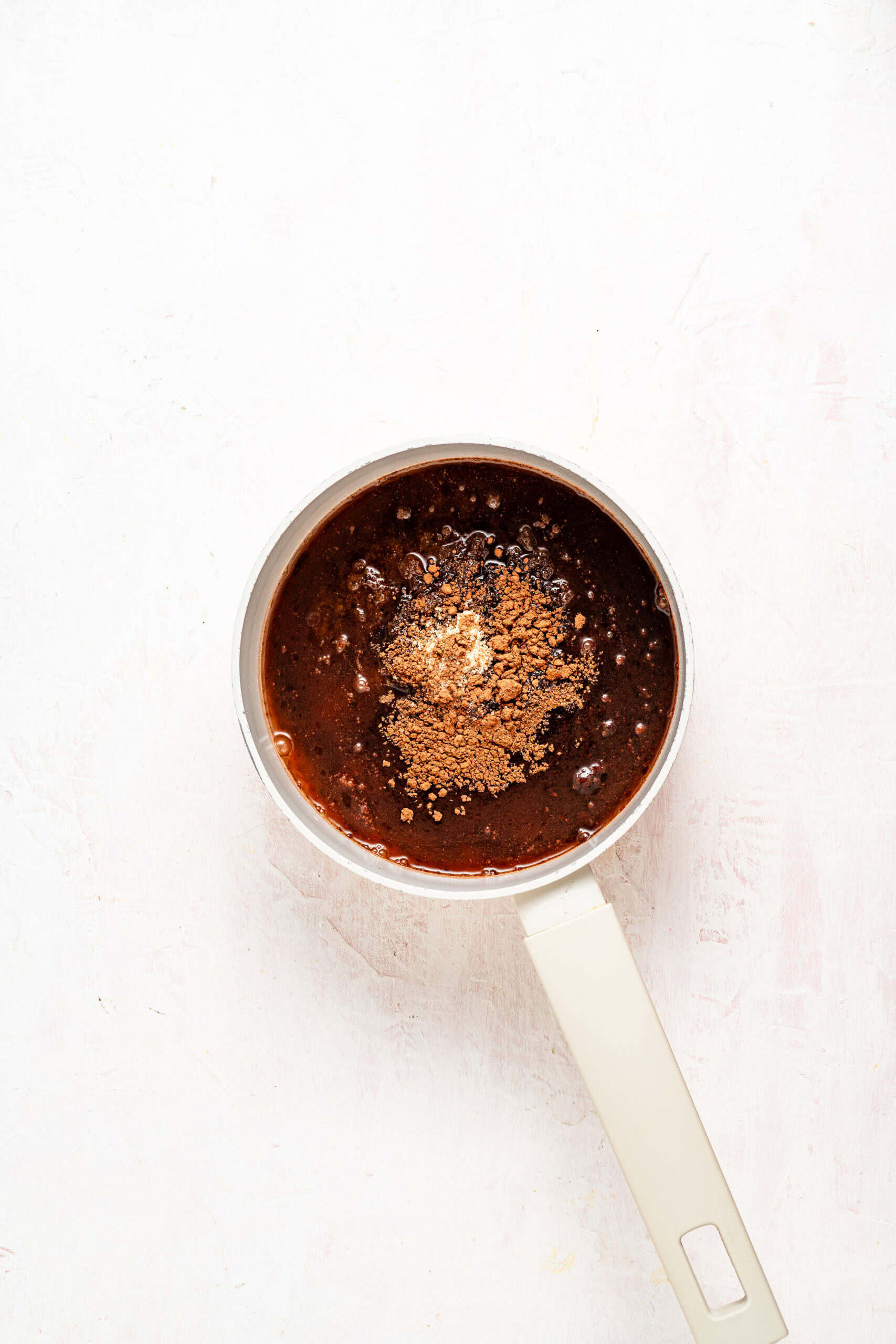 Dark sugar and molasses combined in a copper saucepan to make kuromitsu - Catherine Zhang Dark sugar and molasses combined in a copper saucepan to make kuromitsu