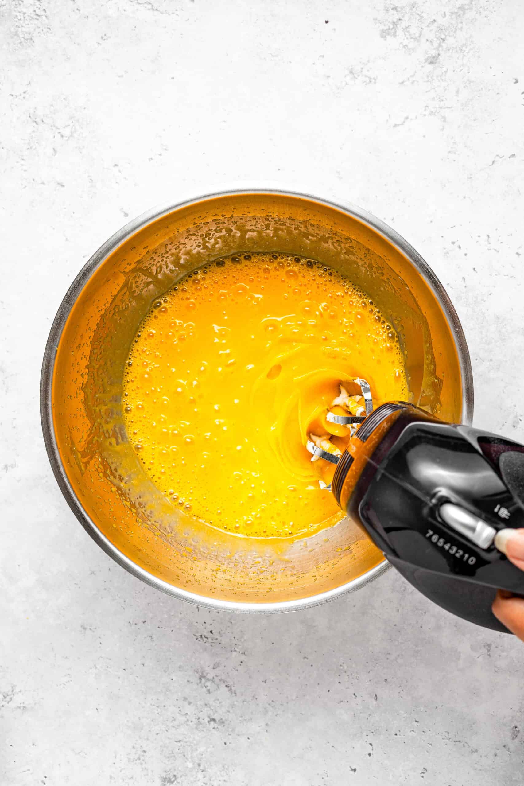 Whisking egg yolks and caster sugar to ribbon stage - Catherine Zhang Whisking egg yolks and caster sugar to ribbon stage