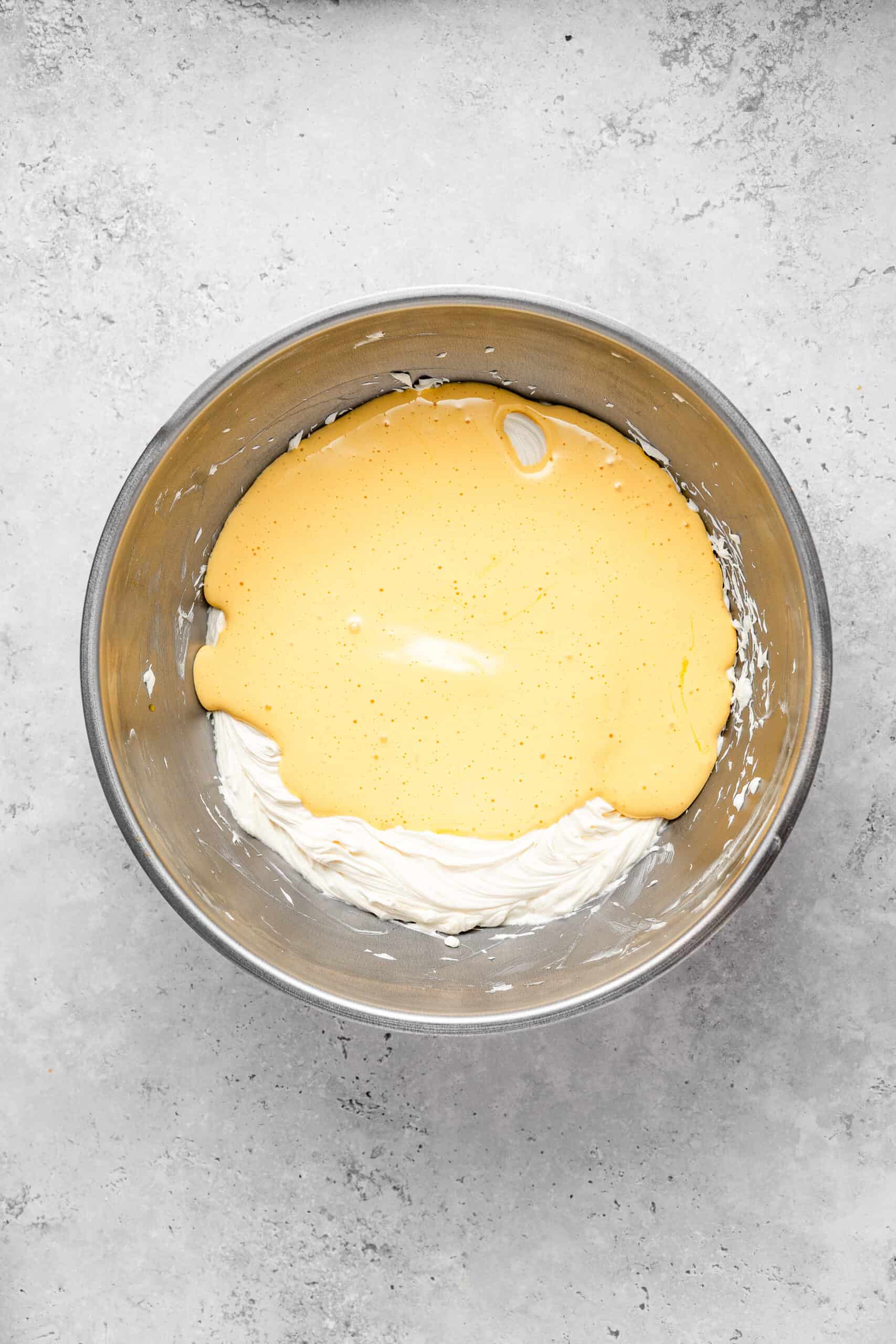 Folding the whipped egg yolks into the butter mixture - Catherine Zhang Folding the whipped egg yolks into the butter mixture