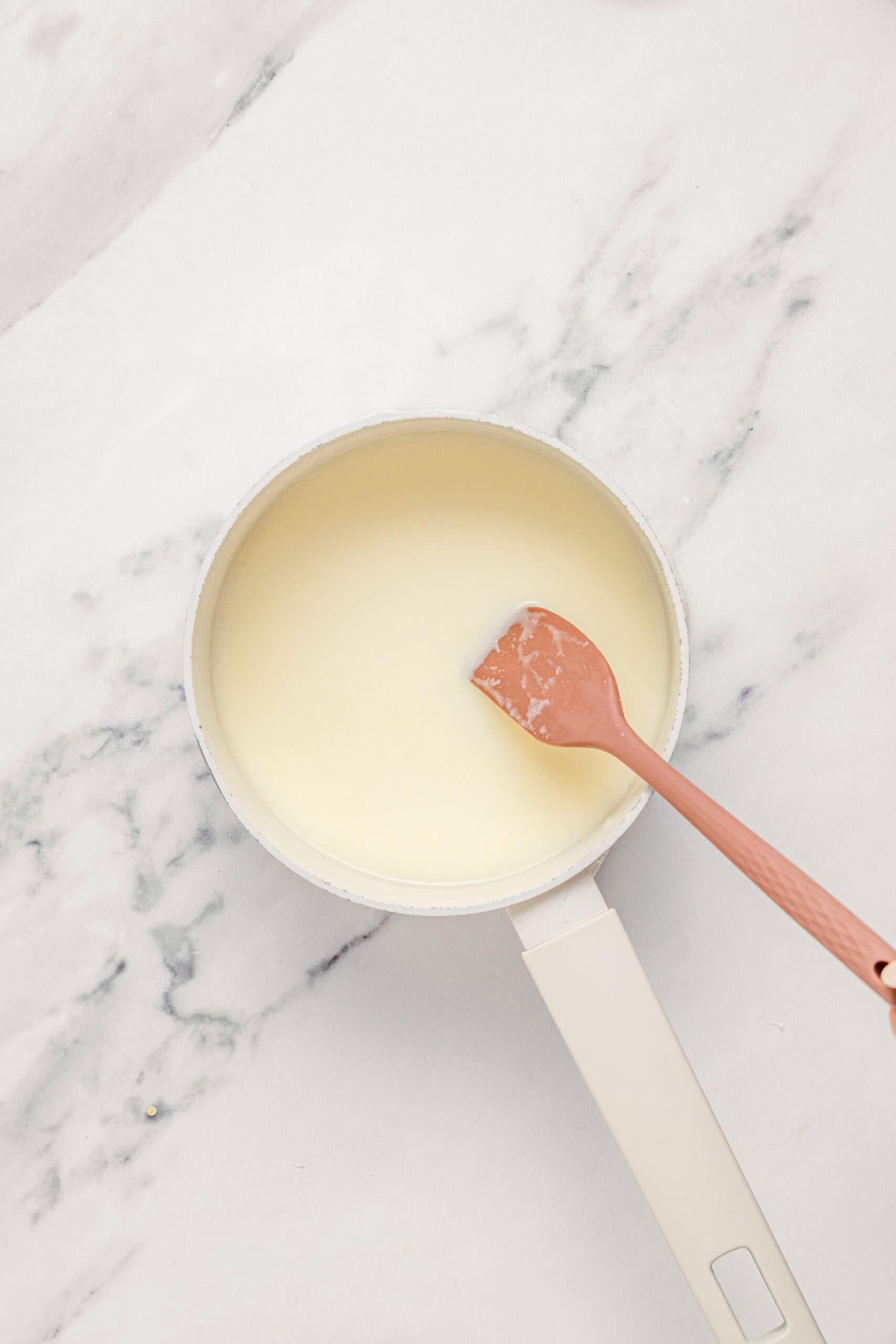 Warmed coconut sauce for che ba mau, smooth and slightly thickened - Catherine Zhang Warmed coconut sauce for che ba mau, smooth and slightly thickened in the pan