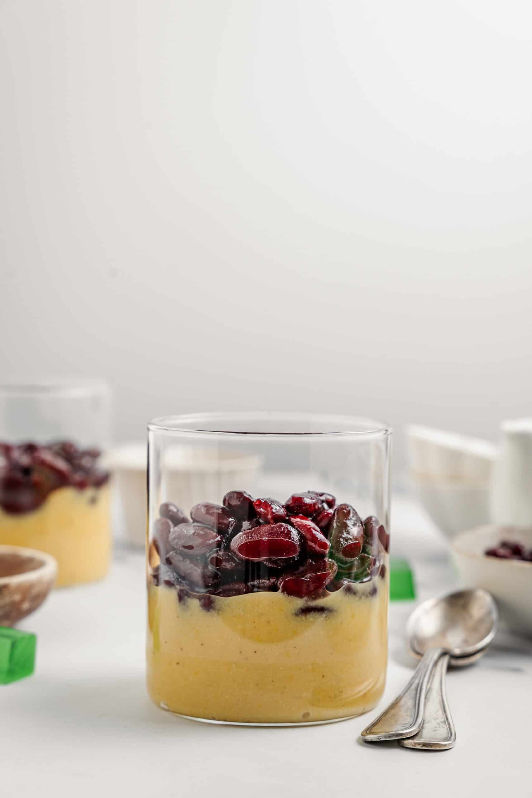 Glass layered with mung bean paste and sweet red beans for che ba mau - Catherine Zhang A glass layered with mung bean paste and sweetened red beans